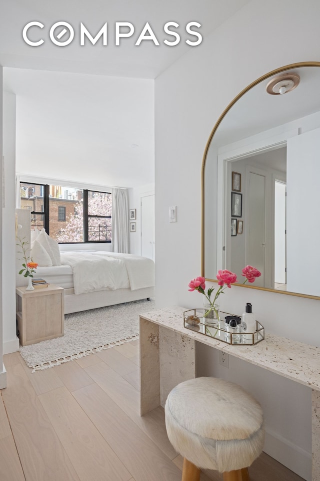 bathroom with wood finished floors and ensuite bath