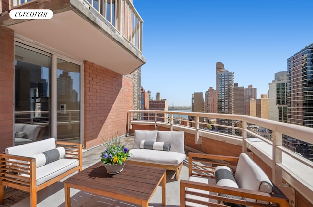 balcony with an outdoor living space and a view of skyline