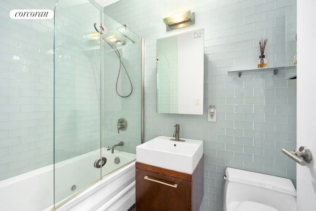 206 E 95th St Unit 16A, New York City, NY 10128 - bathroom with tile walls, vanity, shower / bath combination with glass door, and decorative backsplash