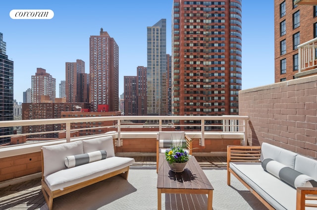 balcony featuring an outdoor living space and a skyline view