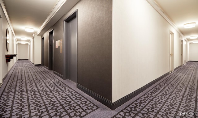 hall with baseboards and ornamental molding