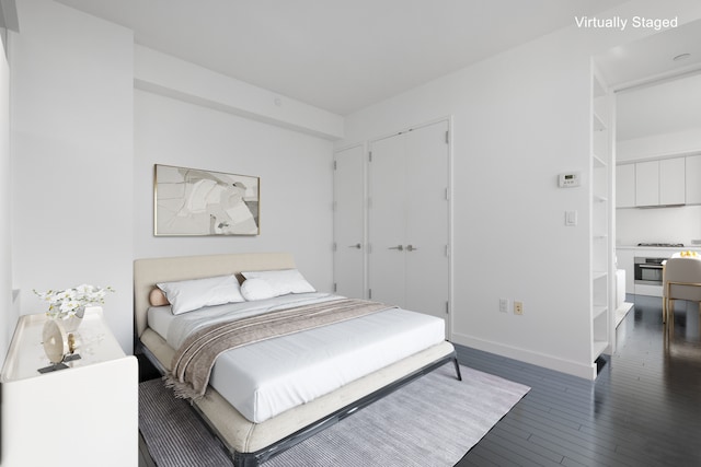 123 Washington St Unit 50H, New York City, NY 10006 - bedroom with hardwood / wood-style flooring, baseboards, and a closet