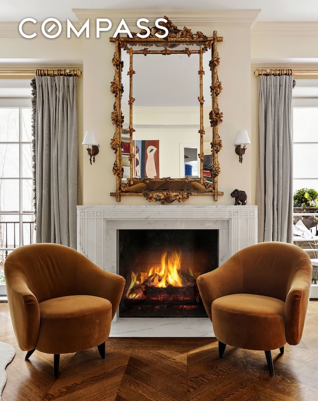 400 W 12th St Unit Th3, New York City, NY 10014 - sitting room featuring ornamental molding, a premium fireplace, healthy amount of natural light, and wood finished floors