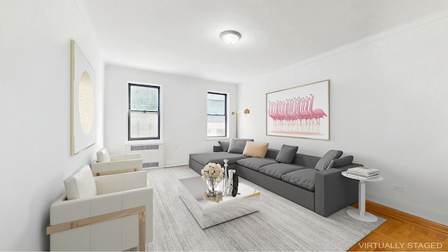 living room featuring baseboards and radiator