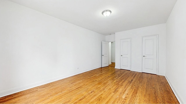 unfurnished bedroom featuring baseboards and light wood-style flooring