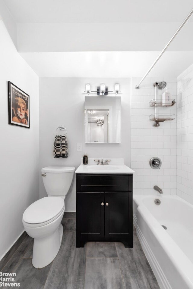 200 E 27th St Unit 6J, New York City, NY 10016 - full bathroom featuring wood finished floors, toilet, vanity, washtub / shower combination, and baseboards