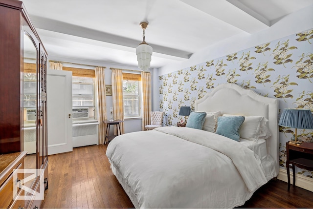 414 E 52nd St Unit 2A, New York City, NY 10022 - bedroom with wallpapered walls, wood-type flooring, beamed ceiling, radiator heating unit, and cooling unit
