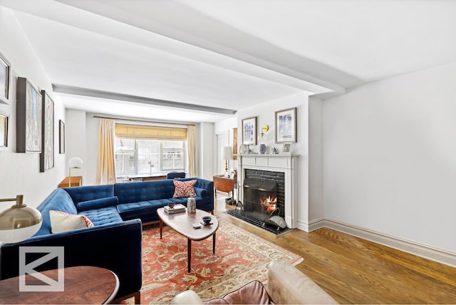 414 E 52nd St Unit 2A, New York City, NY 10022 - living area featuring wood finished floors and a lit fireplace