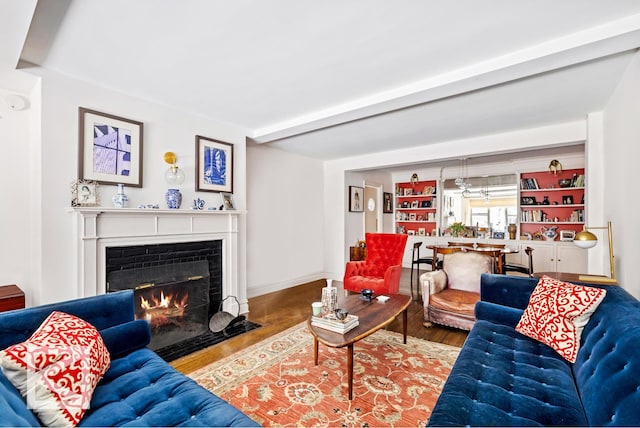 414 E 52nd St Unit 2A, New York City, NY 10022 - living room with a fireplace with flush hearth and wood finished floors