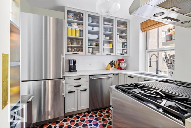 414 E 52nd St Unit 2A, New York City, NY 10022 - kitchen featuring appliances with stainless steel finishes, light countertops, glass insert cabinets, and white cabinetry