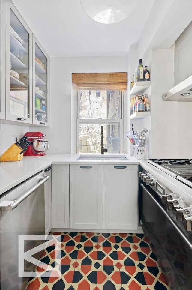 414 E 52nd St Unit 2A, New York City, NY 10022 - kitchen with dishwasher, stove, light countertops, and glass insert cabinets