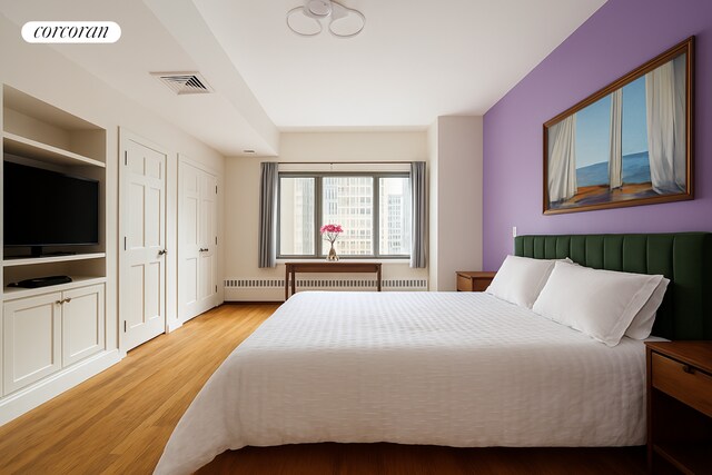 176 Broadway Unit 12E, New York City, NY 10038 - bedroom with visible vents and light wood-type flooring