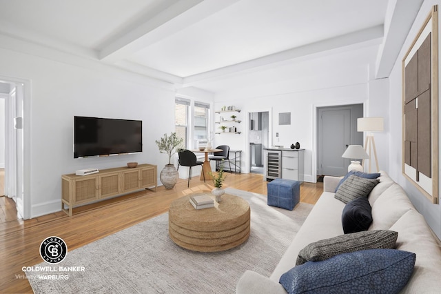 living room featuring wood finished floors, baseboards, wine cooler, and beam ceiling