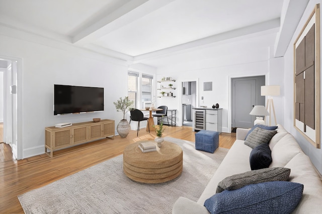 425 E 51st St Unit 5G, New York City, NY 10022 - living room featuring wine cooler, beam ceiling, and wood finished floors
