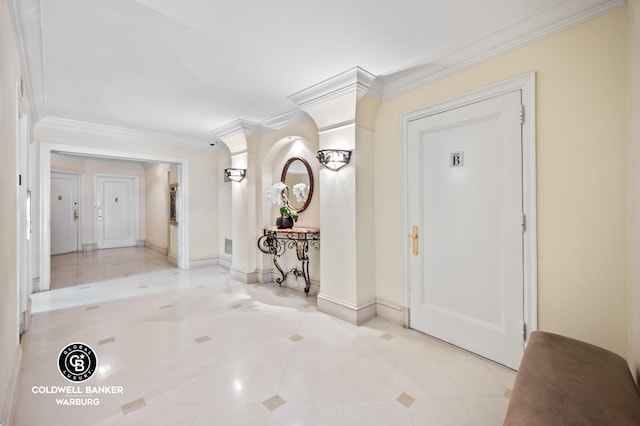 tiled foyer featuring baseboards and ornamental molding