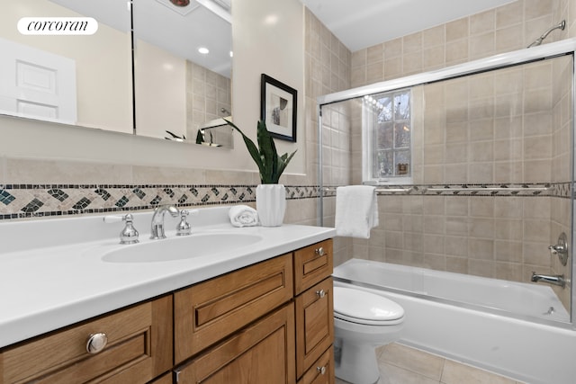 full bathroom with tile patterned flooring, vanity, toilet, shower / bath combination, and tile walls