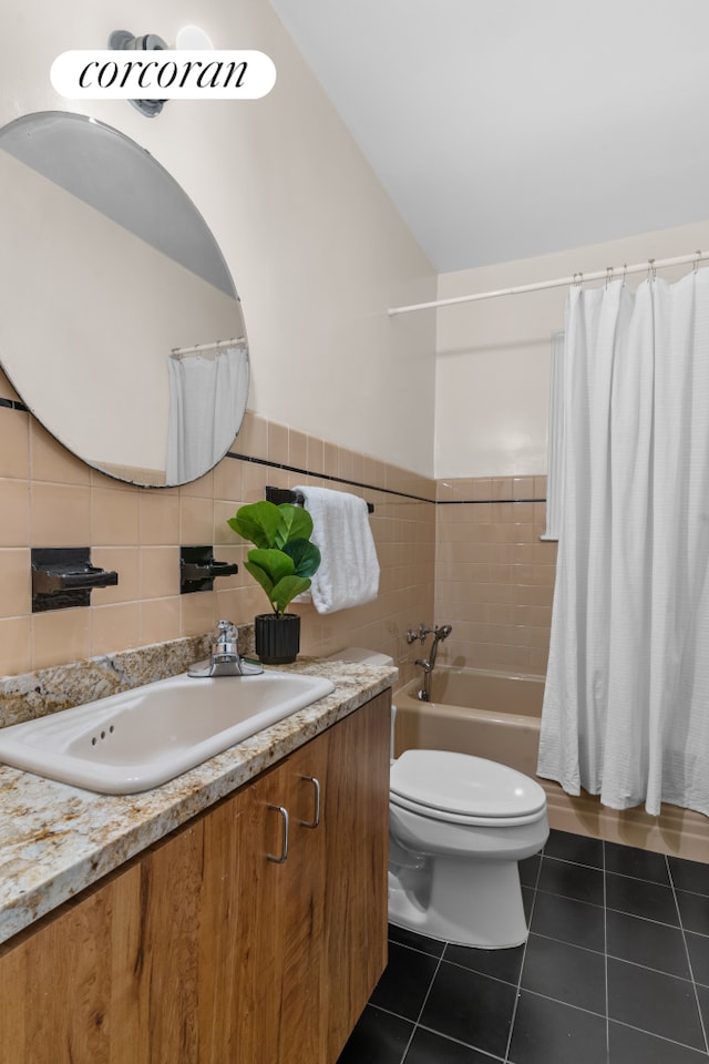 bathroom featuring tile patterned flooring, vanity, toilet, tile walls, and shower / bath combo
