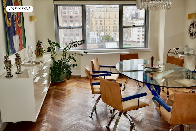 dining space with a chandelier and baseboards