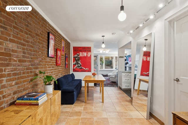 450 W 20th St Garden, Unit Garden, New York City, NY 10011 - interior space featuring brick wall, light tile patterned floors, ornamental molding, rail lighting, and baseboards