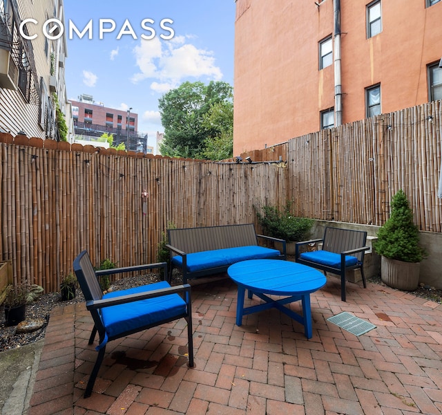 view of patio featuring a fenced backyard and outdoor lounge area