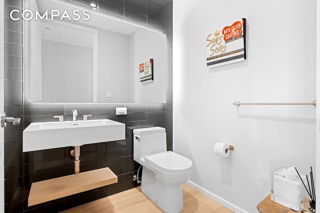 98 Front St Ph, Ph, New York City, NY 11201 - half bathroom with toilet, tile walls, a sink, and wood finished floors