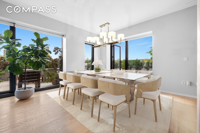 98 Front St Ph, Ph, New York City, NY 11201 - dining room featuring baseboards, light wood-style flooring, and a chandelier