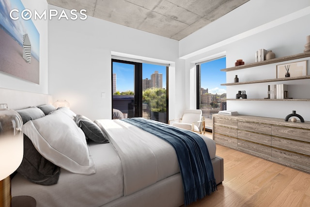 98 Front St Ph, Ph, New York City, NY 11201 - bedroom with light wood-style floors, a city view, and access to exterior