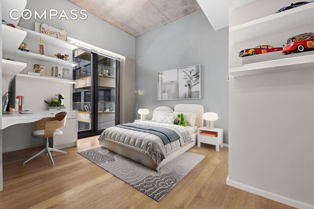 98 Front St Ph, Ph, New York City, NY 11201 - bedroom featuring baseboards, built in study area, wood finished floors, and access to exterior