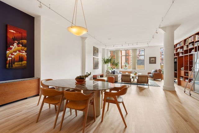 252 7th Ave Unit 6W, New York City, NY 10001 - dining room featuring rail lighting and light wood-type flooring