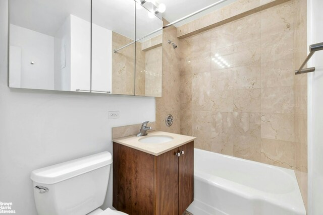 bathroom featuring shower / bath combination, toilet, and vanity