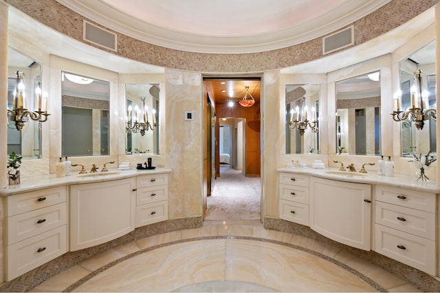 349 W 86th St, New York City, NY 10024 - full bathroom with a chandelier, two vanities, inlaid floor details, and ornamental molding