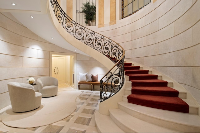 349 W 86th St, New York City, NY 10024 - stairs with tile walls, inlaid floor details, recessed lighting, and a towering ceiling