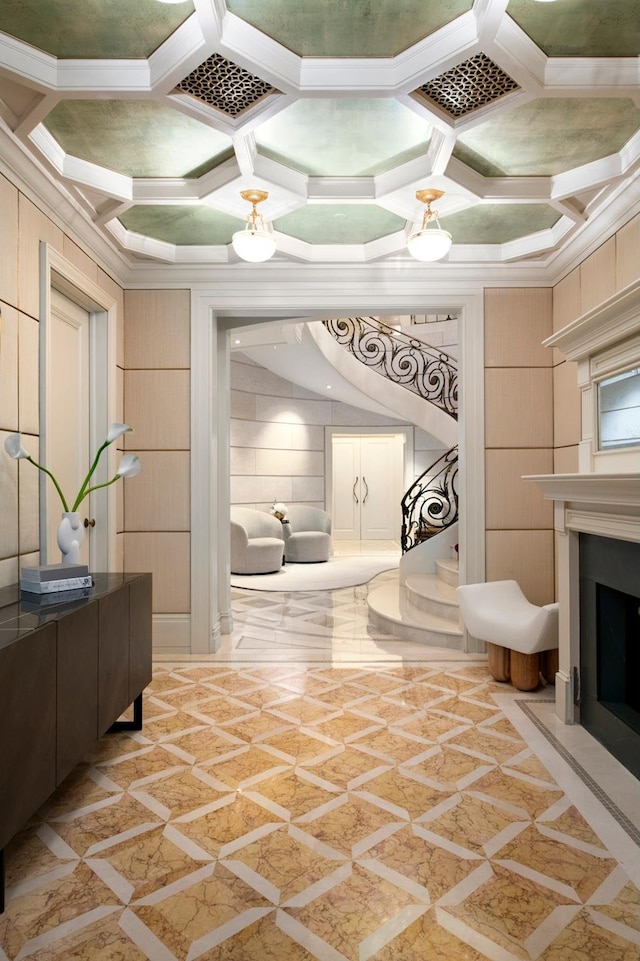 349 W 86th St, New York City, NY 10024 - living room featuring inlaid floor details, coffered ceiling, crown molding, a fireplace, and wooden walls