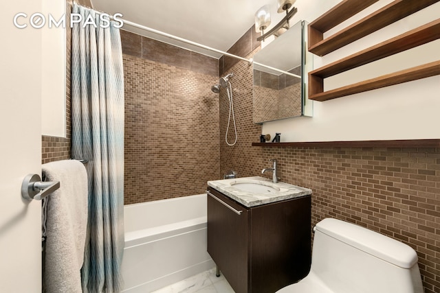 full bath with tile walls, vanity, toilet, shower / tub combo, and marble finish floor