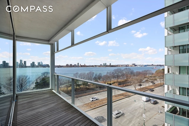 exterior space featuring a view of skyline, a water view, and a balcony