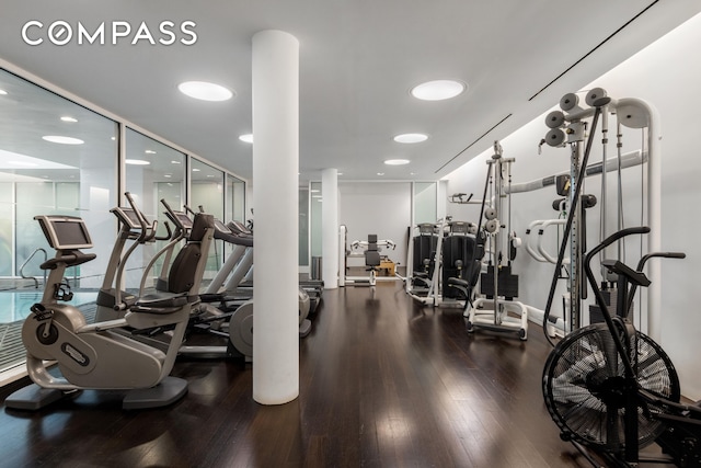 exercise room with wood finished floors and recessed lighting