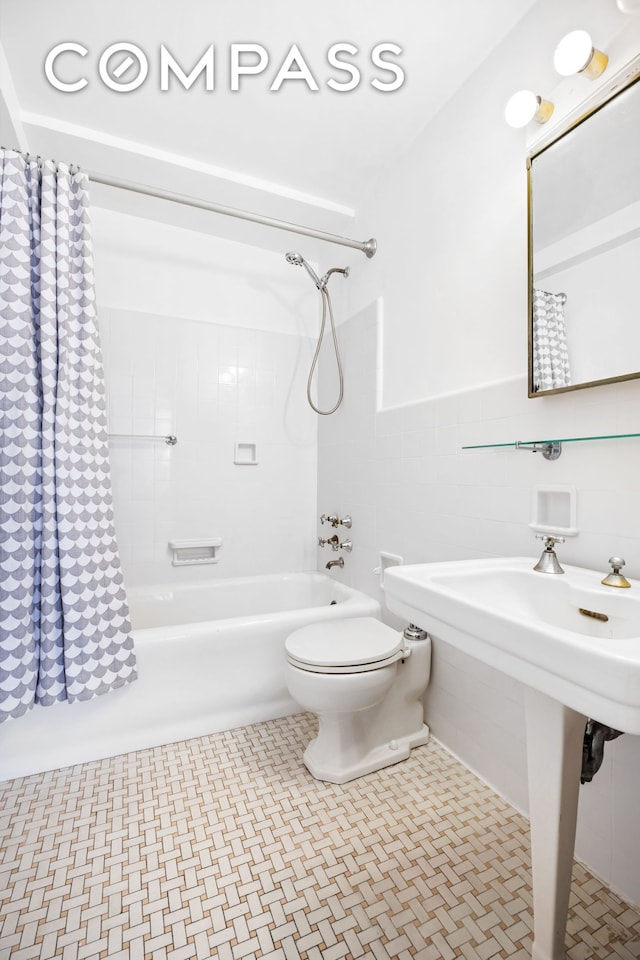 2 Horatio St Unit 8F, New York City, NY 10014 - bathroom featuring shower / bathtub combination with curtain, toilet, tile walls, and a wainscoted wall