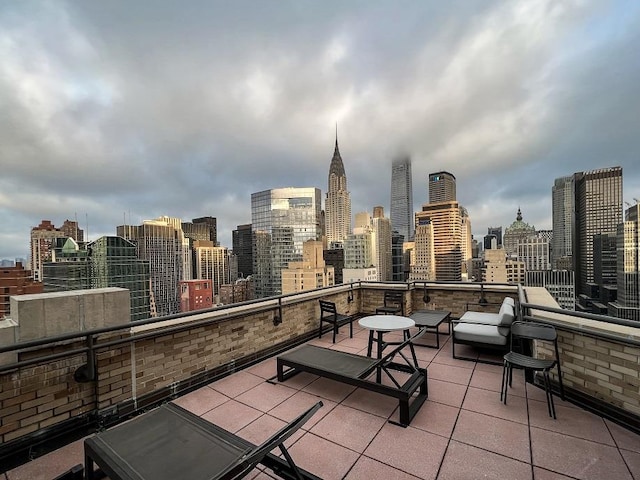 310 E 46th St Unit 15-E, New York City, NY 10017 - view of patio with a skyline view and a balcony