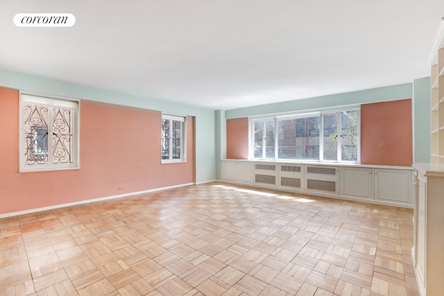 unfurnished room with visible vents and baseboards