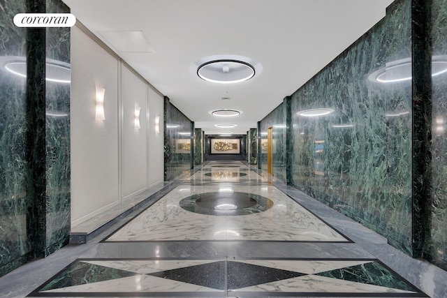 hallway with marble finish floor