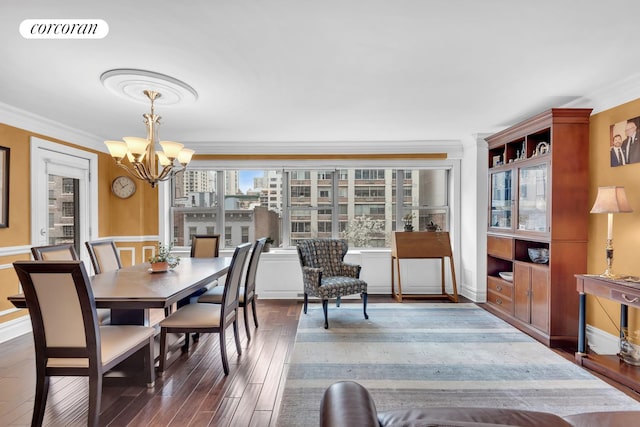 dining space with an inviting chandelier, crown molding, wood finished floors, and visible vents
