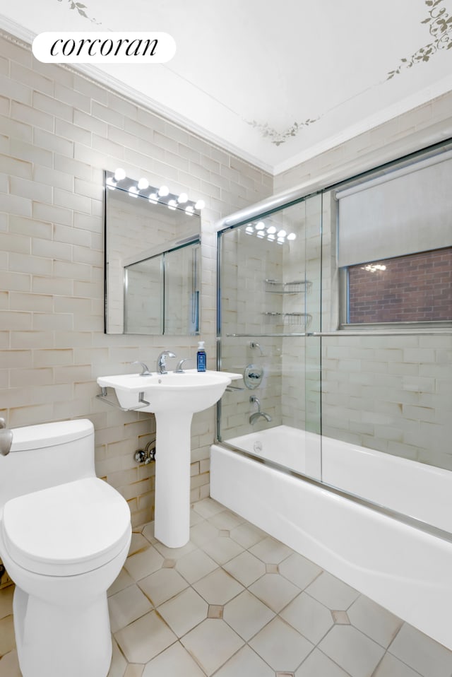 bathroom with tile walls, tile patterned flooring, enclosed tub / shower combo, and toilet
