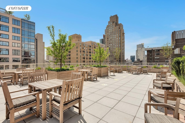 view of patio featuring a city view and outdoor dining space