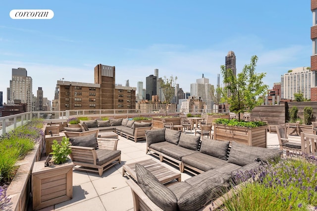 view of patio featuring a garden, an outdoor living space, and a view of city
