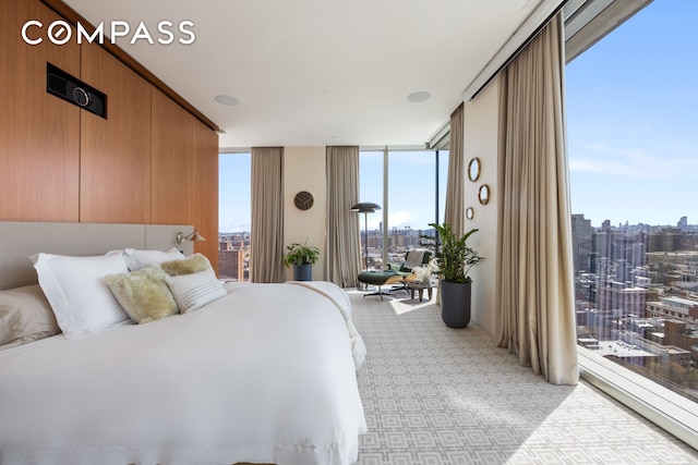 215 Chrystie St Unit Ph3, New York City, NY 10002 - bedroom featuring light carpet, a wall of windows, and a view of city