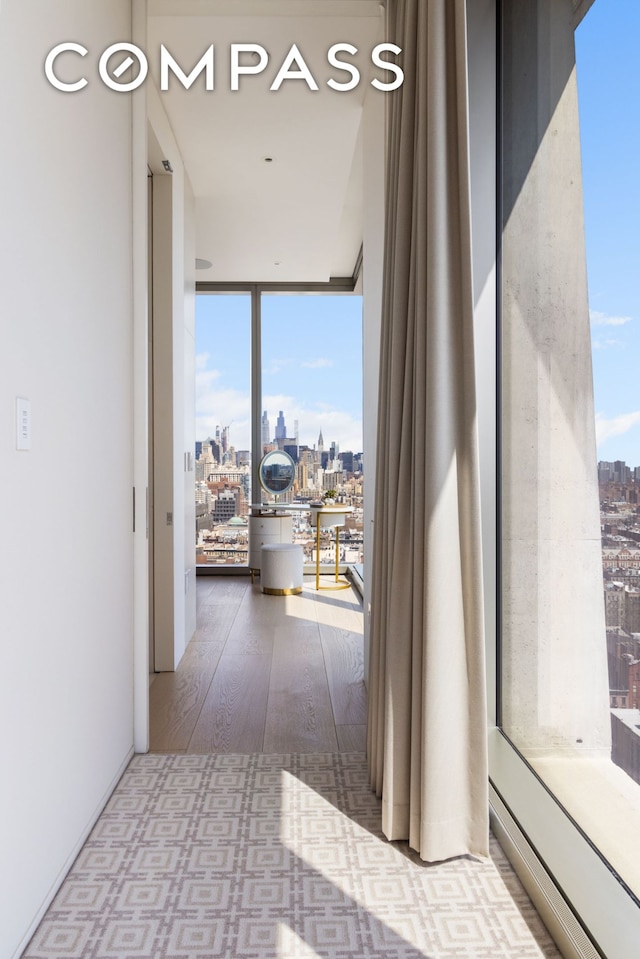 215 Chrystie St Unit Ph3, New York City, NY 10002 - corridor featuring floor to ceiling windows, wood finished floors, and a view of city