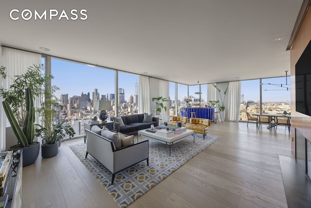 215 Chrystie St Unit Ph3, New York City, NY 10002 - living room with floor to ceiling windows, a city view, and wood-type flooring
