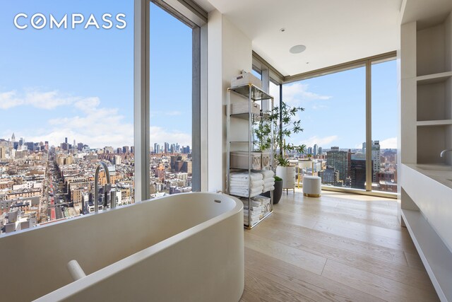 215 Chrystie St Unit Ph3, New York City, NY 10002 - corridor with a wall of windows, wood finished floors, and a view of city