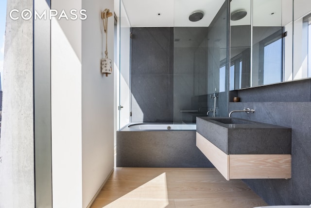 215 Chrystie St Unit Ph3, New York City, NY 10002 - full bathroom with a garden tub, walk in shower, wood finished floors, and vanity