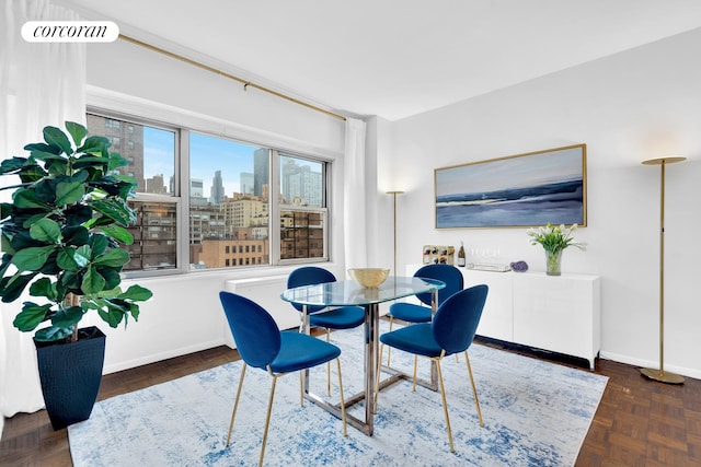 360 E 72nd St Unit B1008, New York City, NY 10021 - dining room with baseboards and a skyline view